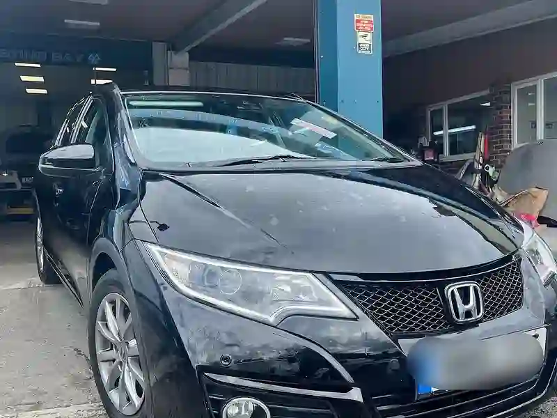 A Honda saloon at the M&S Garage workshop entrance