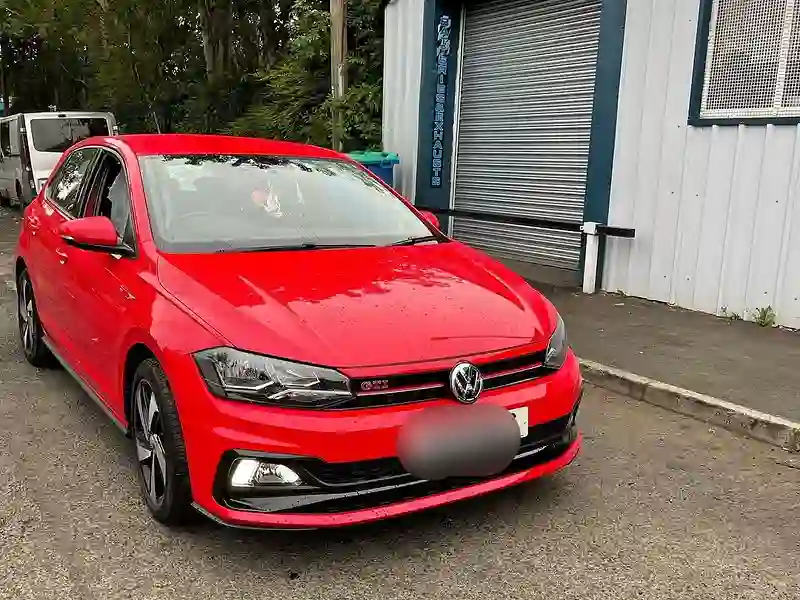 A red Volkswagen Polo outside the M&S Garage unit